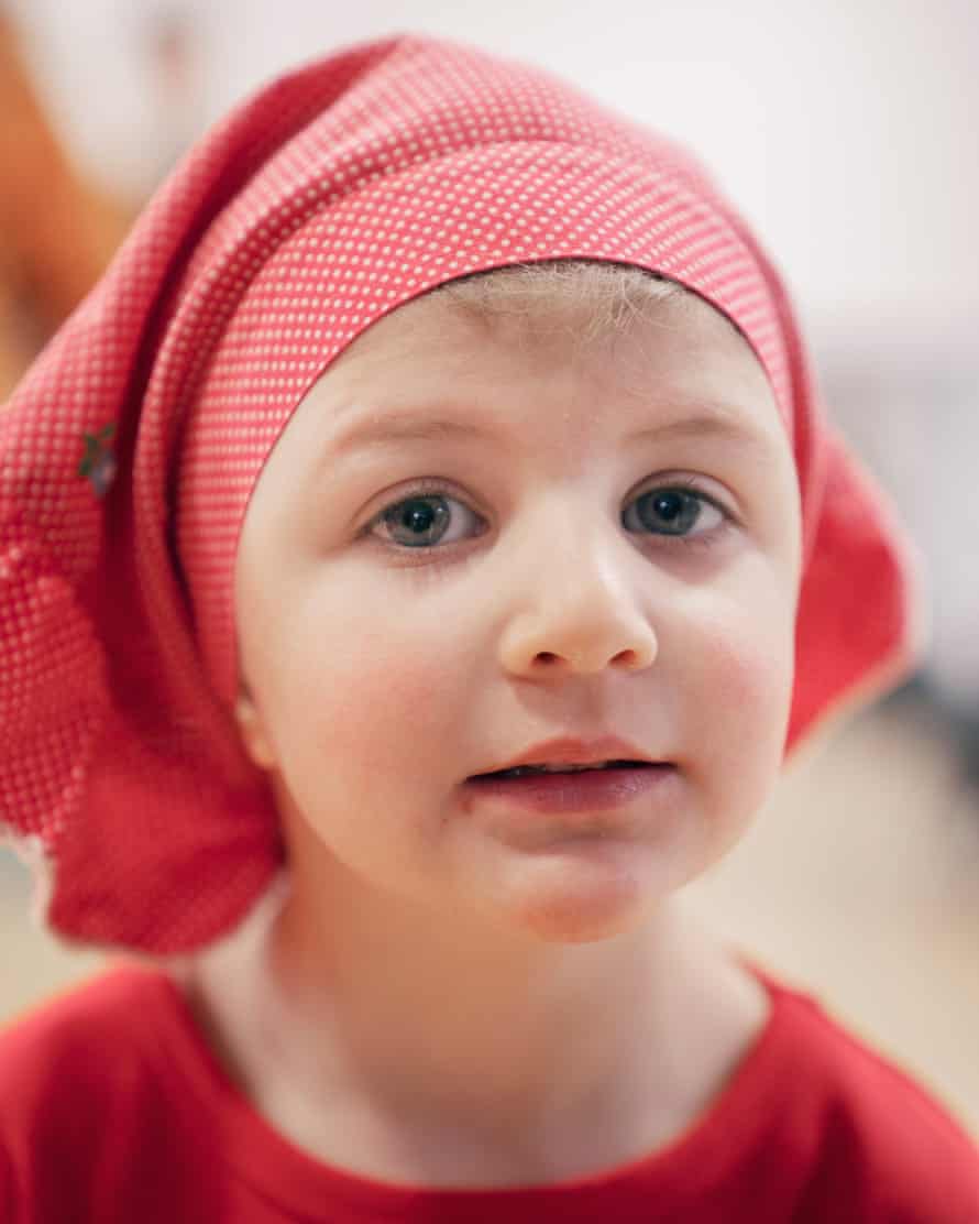 Rachel, three, who also attends Orot, wears a Little Red Riding Hood Purim cap that once belonged to her mother.